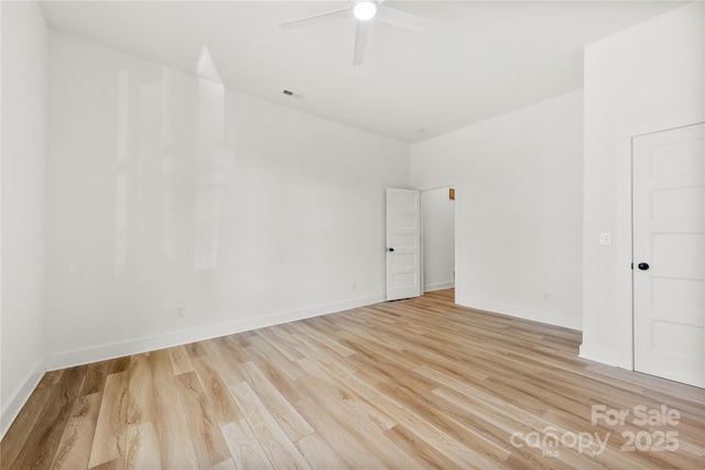 empty room with light wood-style floors, a ceiling fan, visible vents, and baseboards