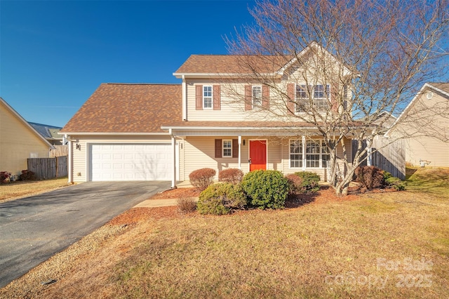 front of property with a garage, a porch, and a front lawn