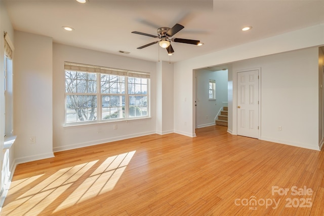 unfurnished living room with ceiling fan and light wood-type flooring