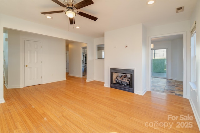 unfurnished living room with light hardwood / wood-style floors and ceiling fan