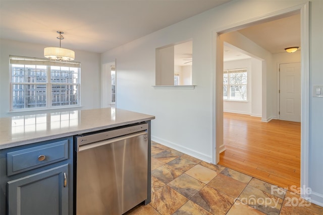 kitchen featuring pendant lighting, stainless steel dishwasher, and plenty of natural light