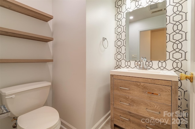 bathroom featuring vanity and toilet