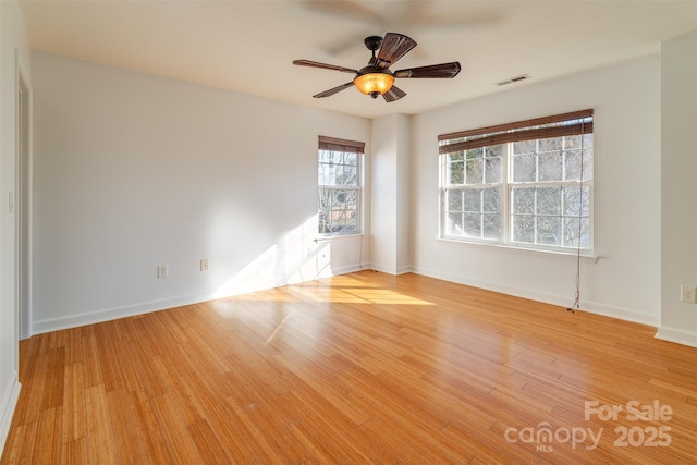 spare room featuring ceiling fan and light hardwood / wood-style flooring