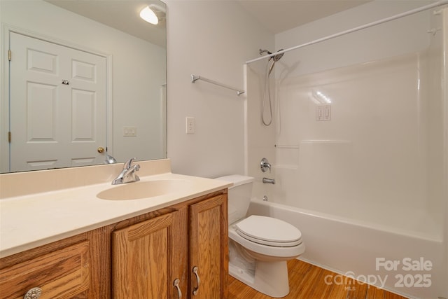 full bathroom featuring vanity, toilet,  shower combination, and hardwood / wood-style floors