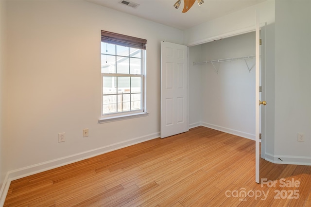 unfurnished bedroom with a closet, ceiling fan, and light wood-type flooring