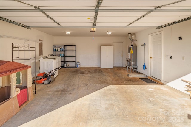 garage with water heater, electric panel, and independent washer and dryer