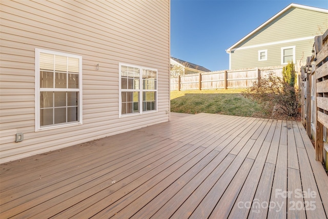 wooden terrace featuring a yard