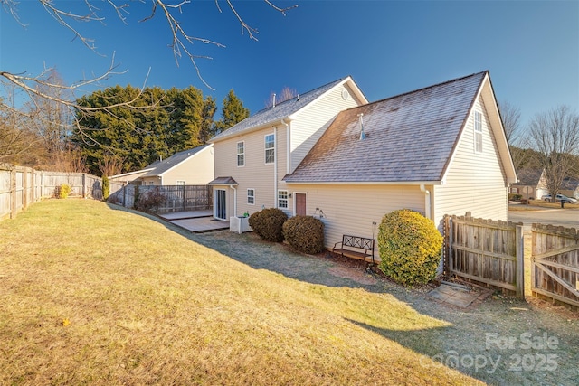 rear view of property with a yard and cooling unit