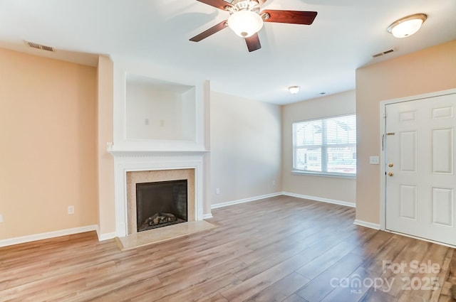 unfurnished living room featuring ceiling fan and light hardwood / wood-style flooring