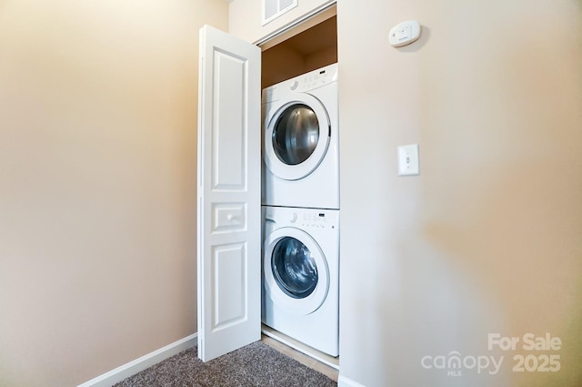 laundry area featuring stacked washer and clothes dryer