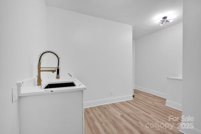 interior space with sink and light hardwood / wood-style floors