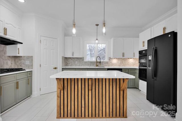 kitchen with white cabinets, black appliances, and a kitchen island