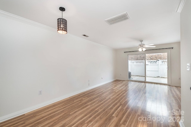 unfurnished room with ceiling fan, crown molding, and wood-type flooring