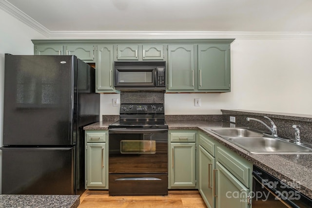 kitchen featuring black appliances, crown molding, sink, and green cabinetry