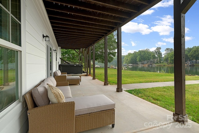 view of patio / terrace with an outdoor living space and a water view