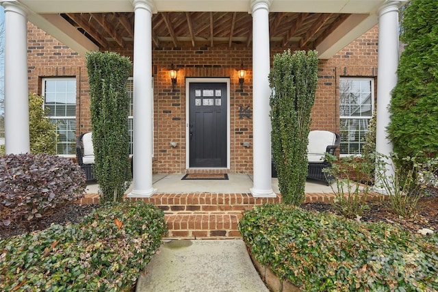 view of exterior entry with a porch