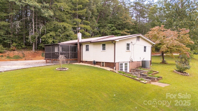 back of house with a yard, central AC, and a sunroom