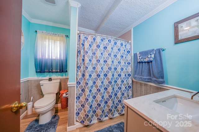 bathroom featuring crown molding, a textured ceiling, toilet, vanity, and hardwood / wood-style flooring