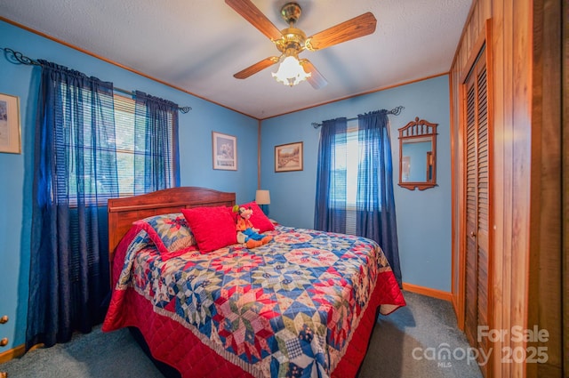 carpeted bedroom featuring ceiling fan and a closet