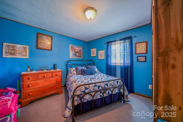 carpeted bedroom featuring a textured ceiling