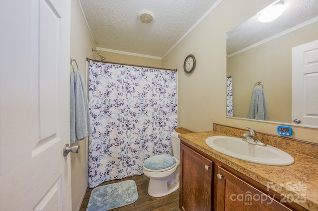 bathroom featuring ornamental molding, vanity, a textured ceiling, wood-type flooring, and toilet