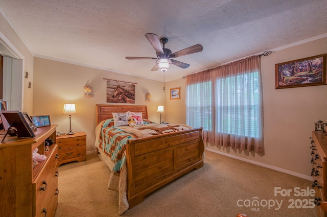 bedroom featuring a textured ceiling, light colored carpet, and ceiling fan