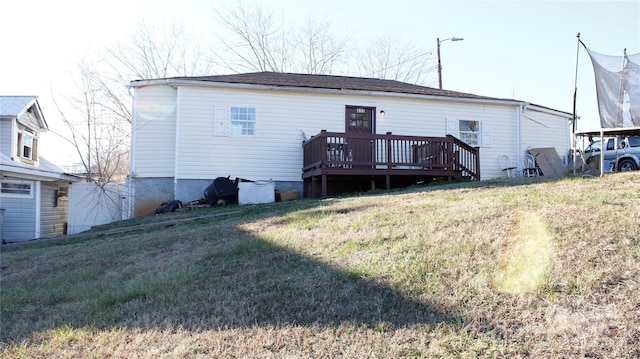 back of house with a yard and a deck