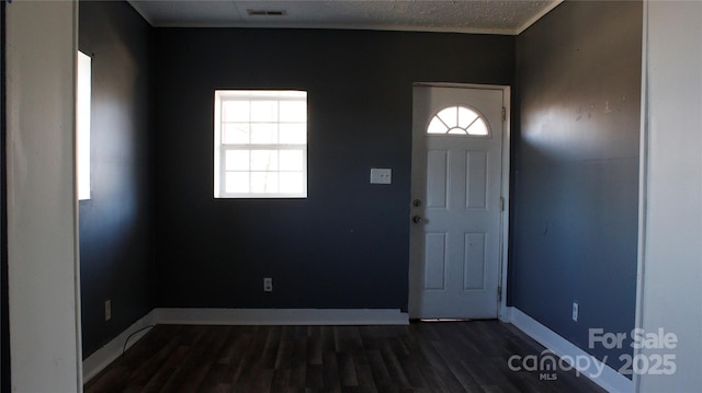 entryway with dark hardwood / wood-style flooring and a textured ceiling