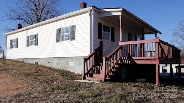 view of property exterior featuring a wooden deck