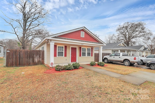 bungalow-style home featuring a front lawn