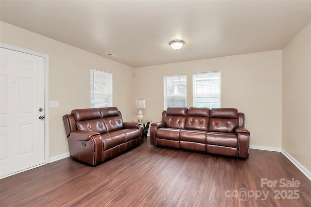 living room with a healthy amount of sunlight and dark hardwood / wood-style floors