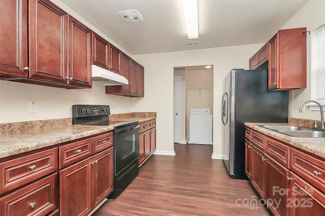 kitchen with washer / clothes dryer, sink, stainless steel fridge, dark hardwood / wood-style flooring, and black / electric stove