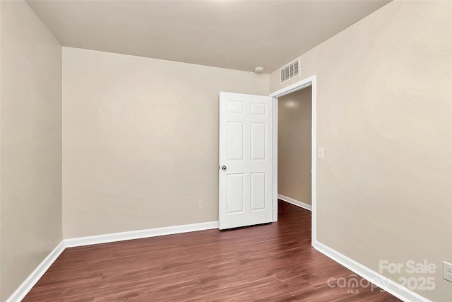 empty room with dark hardwood / wood-style floors