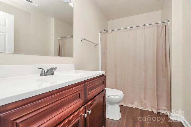 bathroom featuring vanity, hardwood / wood-style floors, and toilet