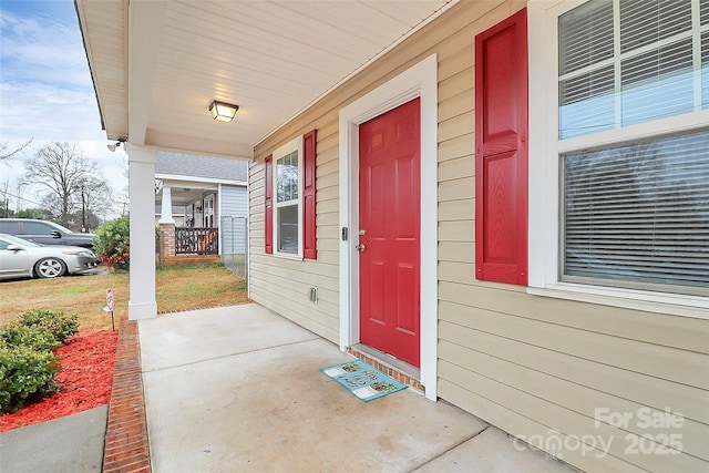 view of exterior entry with covered porch