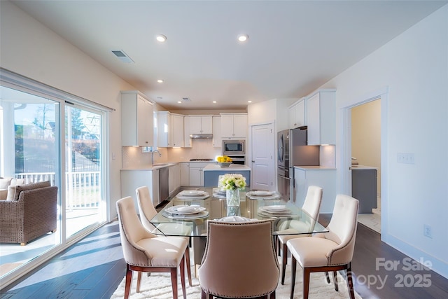 dining area with wood-type flooring and sink