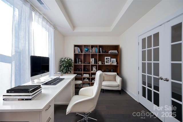 office area with a tray ceiling, french doors, and dark hardwood / wood-style floors