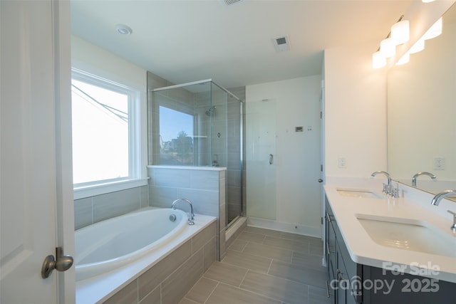 bathroom featuring tile patterned floors, plus walk in shower, and vanity