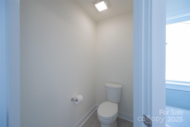 bathroom with tile patterned flooring and toilet