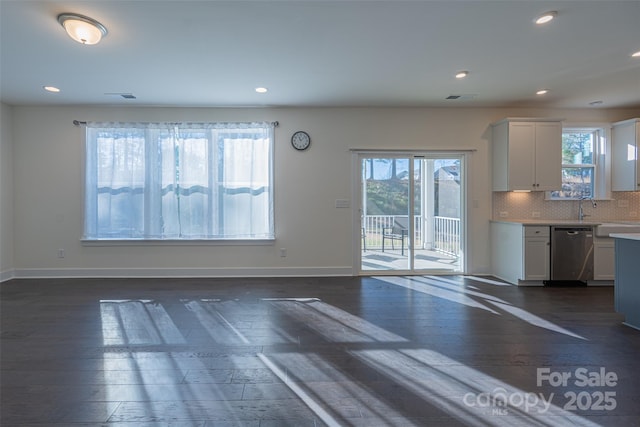 kitchen featuring white cabinets, decorative backsplash, dark hardwood / wood-style floors, and dishwasher