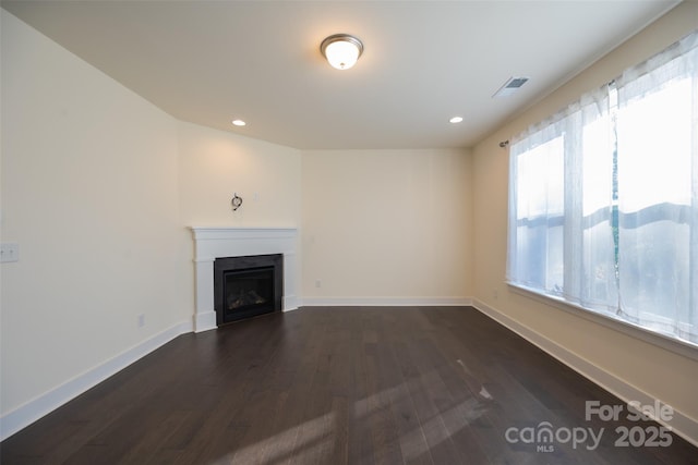 unfurnished living room with dark hardwood / wood-style floors