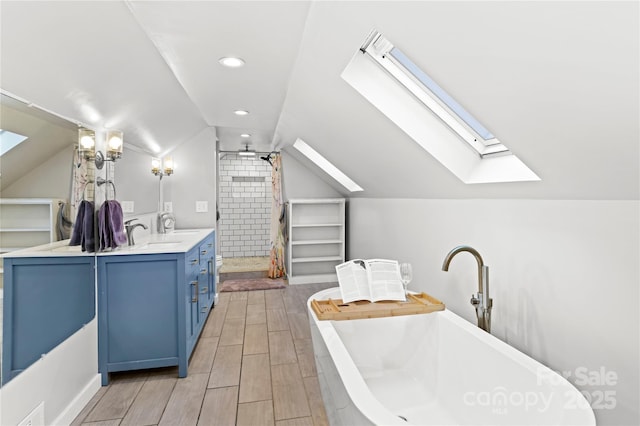 bathroom with vanity, a bath, and lofted ceiling