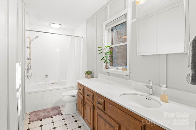 full bathroom featuring vanity, shower / bath combination with curtain, and toilet