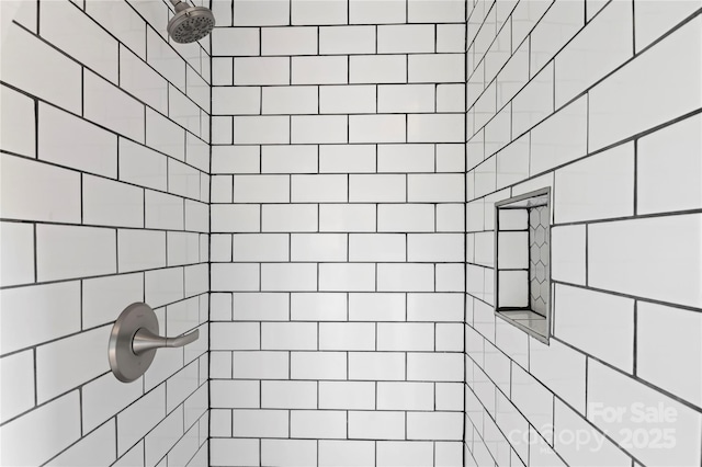 bathroom with a tile shower