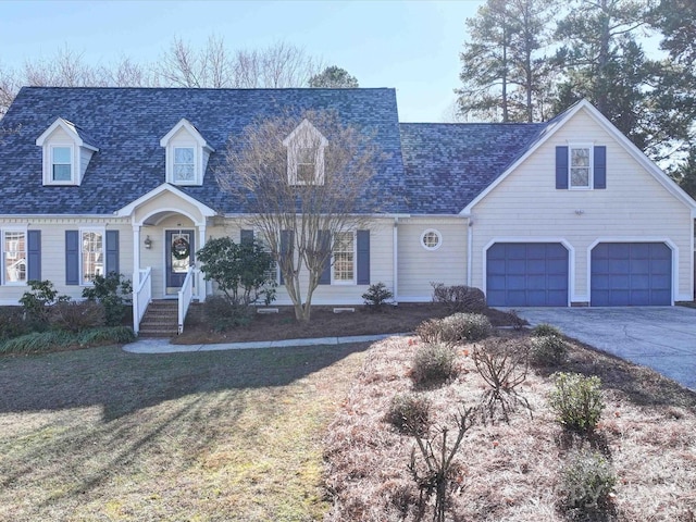 cape cod house with a front yard and a garage