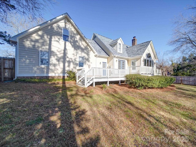 back of property featuring a yard and a deck