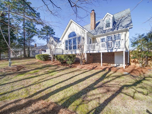 rear view of house with a yard and a wooden deck