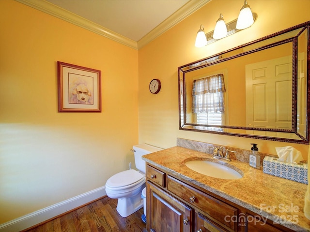 bathroom with hardwood / wood-style floors, vanity, toilet, and crown molding