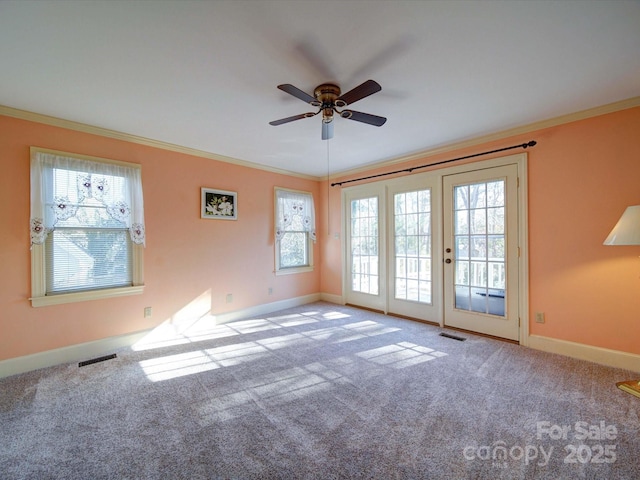 unfurnished room with ceiling fan, light colored carpet, and ornamental molding