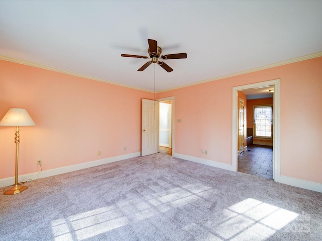 carpeted empty room with ceiling fan and crown molding